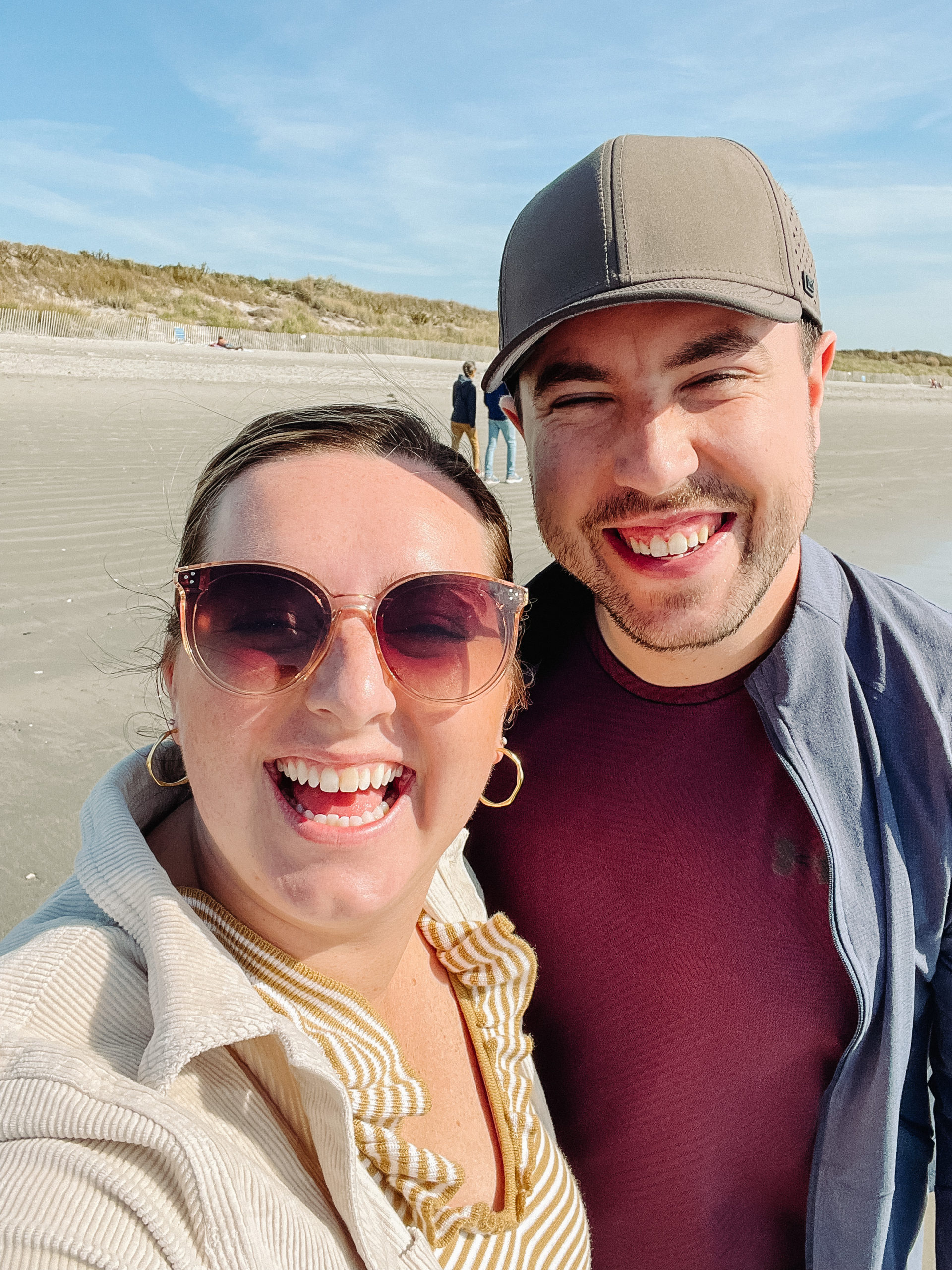 couple smiling at the beach in new england