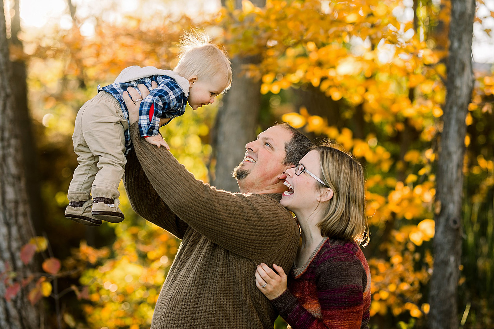 photograph of family with toddler in fall