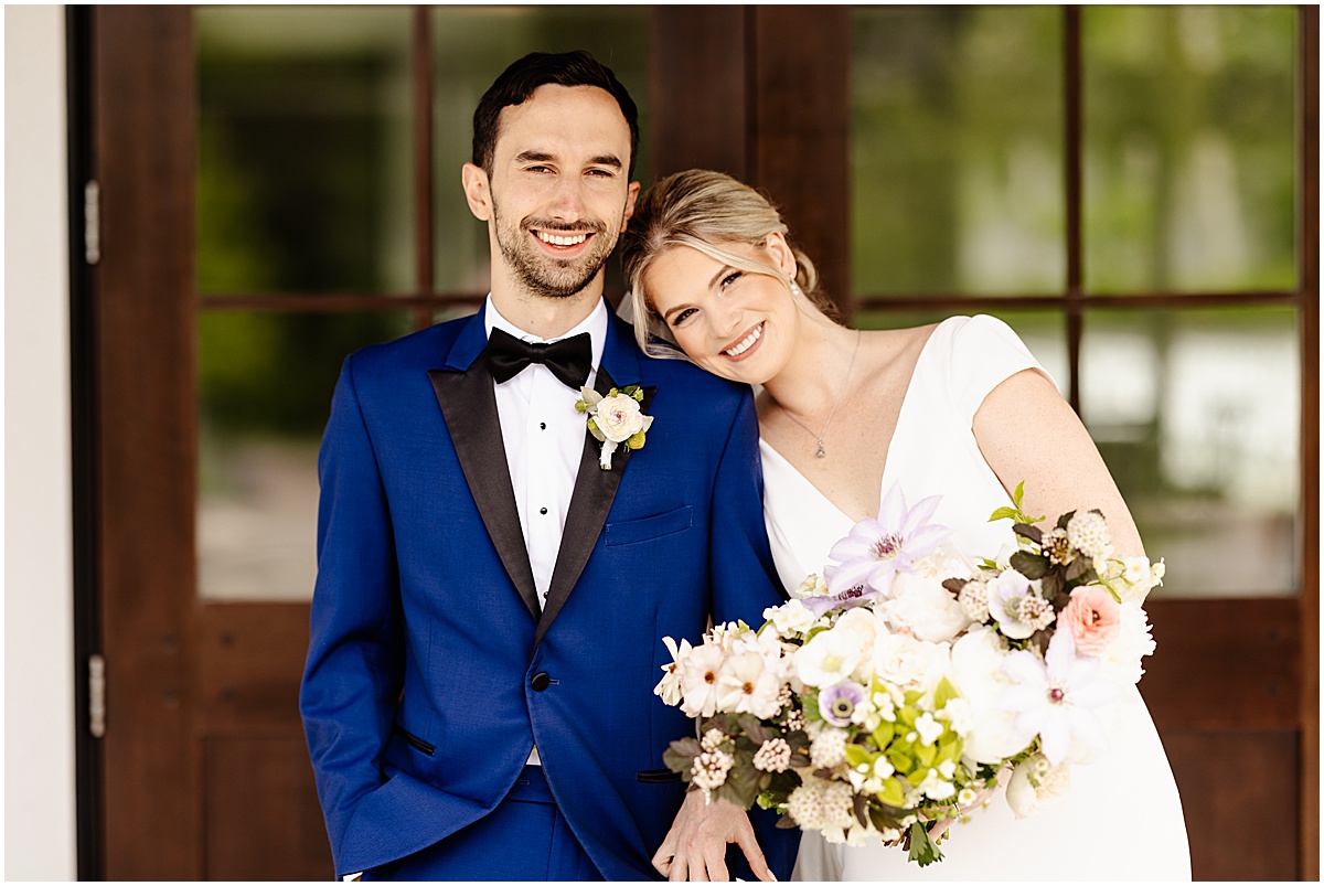 Bride and groom portraits outside The Hutton House with Kindred Blooms florals
